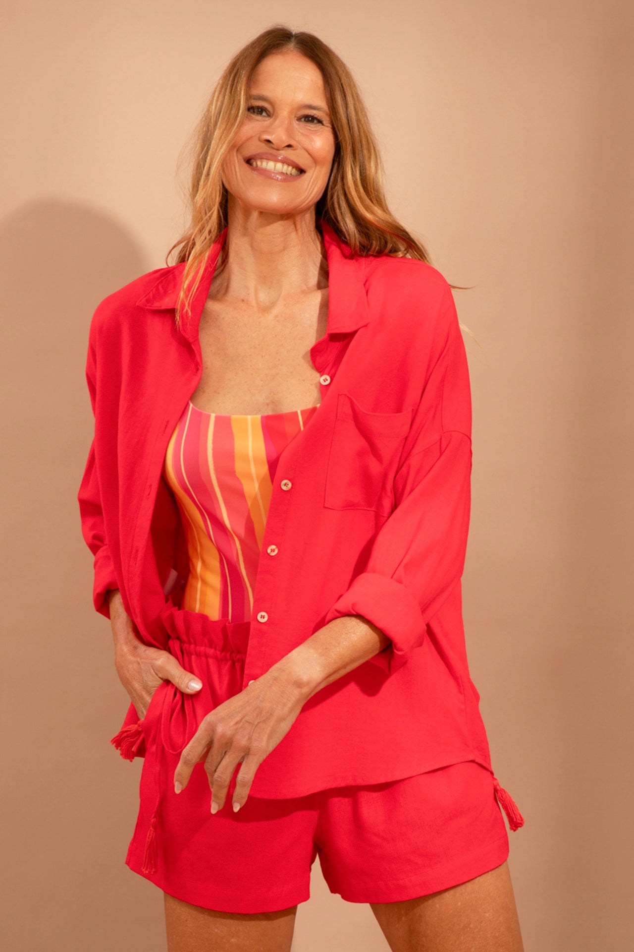 Fotografia de camisão Lizy em estampa flor vermelho tomate, fechamento frontal solto com botões finos, ombros deslocados e decote elegante nas costas, marca Isa Rodrigues Resortwear.